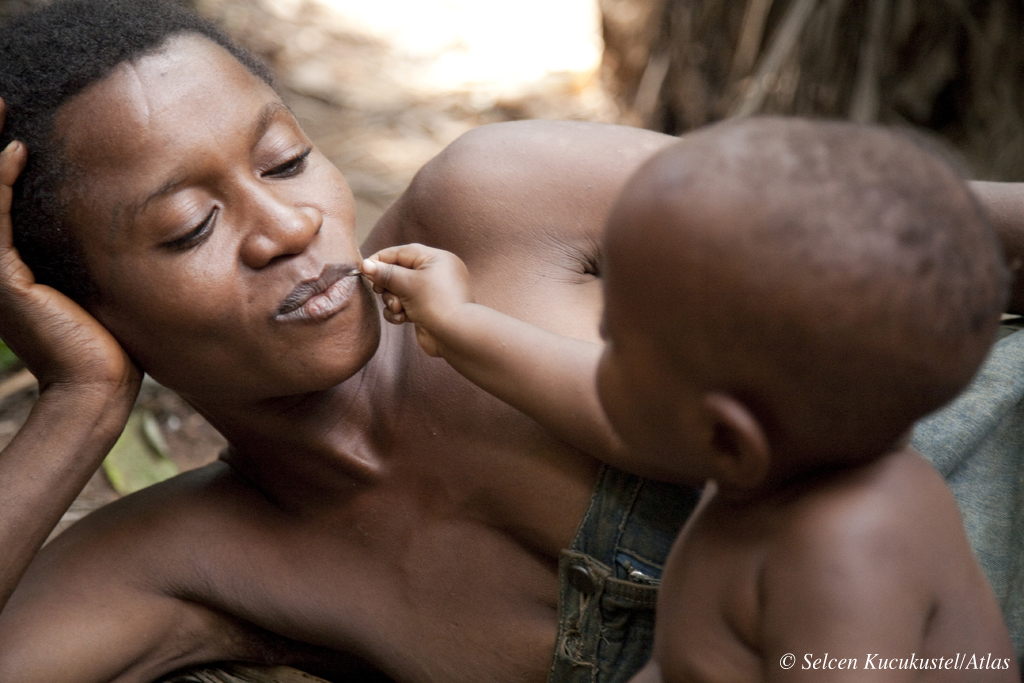 A Baka child playing with her mother, Cameroon.